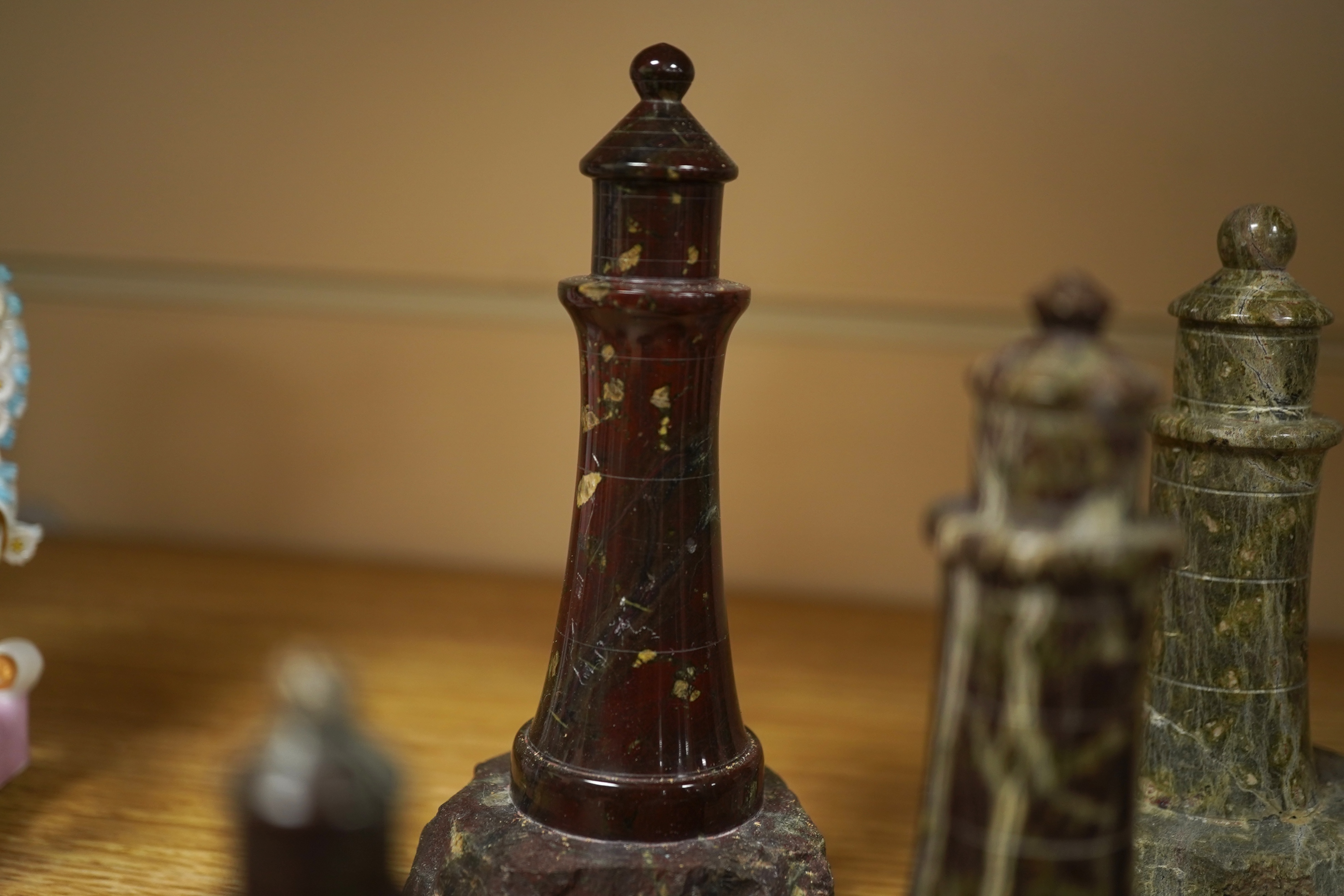 A collection of Cornish serpentine stone carved lighthouses, tallest 13cm high